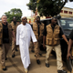 Incumbent president Alpha Conde leaves a polling station in Conakry.